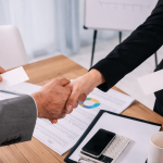 Business handshake during financial consultation with Chartered Accountant in Ahmedabad